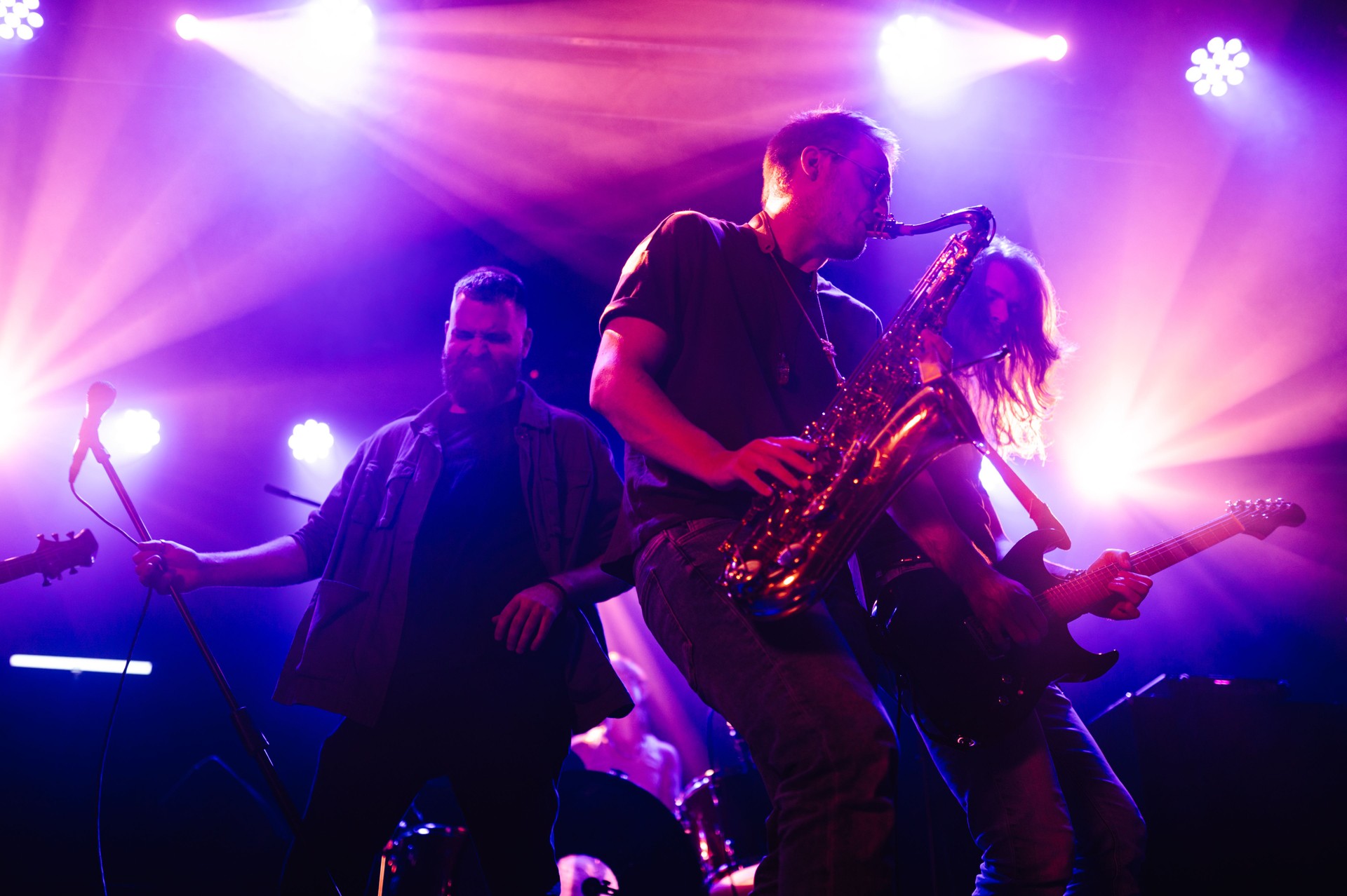 Musicians playing saxophone and guitar on stage